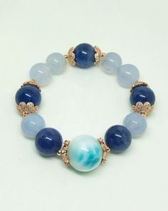 Unique high Quality 18.2mm Larimar with 14.2mm Tanzanite and 13.8mm mix 13mm Blue Chalcedony crystal bracelet. A high quality Larimar leads this bracelet with a superb calming and intelligent energy followed by natural Tanzanite and Chalcedony to harmonize the energies. This is One of a Kind crystal bracelet that combines & harmonises the exquisite healing powress of Larimar, Tanzanite & Chalcedony. Ideal for healers, good career EQ and past life awareness for better future. Larimar is h Sapphire Jewelry With 8mm Beads, Blue Moonstone Beaded Bracelets With Gemstone Beads, Handmade Blue Moonstone Beaded Bracelets, Blue Larimar Jewelry With Gemstone Beads, Sapphire Gemstone Beads Bracelets, Handmade Blue Moonstone Bracelets, Blue Aquamarine Natural Stone Bracelets, Blue Aquamarine Gemstone Bracelets, Blue Aquamarine 8mm Beads Jewelry