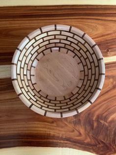 a wooden bowl sitting on top of a table