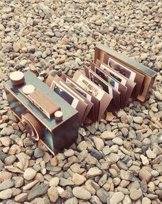 an old stereo sitting on top of a pile of rocks next to another set of records