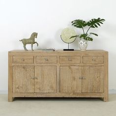 a wooden sideboard with two vases and a horse figurine on top