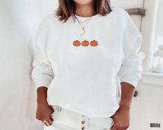 This soft and cozy Embroidered Pumpkin Sweatshirt is bound to keep you warm in the colder months. The perfect Spooky Season Halloween gift or crewneck sweatshirt to add to your wardrobe! Please note that the design is EMBROIDERED. Please note that due to variations in monitors & lighting the colors of the fabric and design may look slightly different in real life. DETAILS * 50% cotton, 50% polyester * Air-jet spun yarn with a soft feel and reduced pilling * Classic fit * Printed and shipped from the USA SIZING * This listing is for 4XL only. Please refer to sizing chart in the photos for exact measurements. For other sizes please follow link to listing https://www.etsy.com/listing/1502749592/embroidered-pumpkin-sweatshirt-pumpkin PRODUCTION & SHIPPING * Order Production: 2-7 days * Standar Oversized White Halloween Sweater, Casual White Sweatshirt For Halloween, Casual White Sweater For Halloween, Embroidered Pumpkin, Halloween Crewneck Sweatshirt, Embroidered Halloween, Pumpkin Sweater, Pumpkin Sweatshirt, Halloween Crewneck