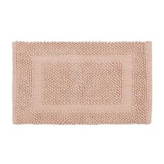 a bath mat with an oval design on the front and back side, in light pink