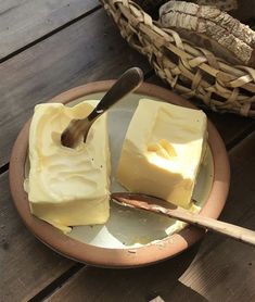 a wooden table topped with a plate of cheese