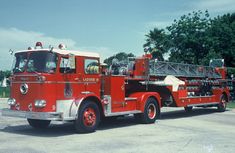 a red fire truck parked in a parking lot