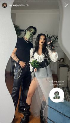 a man and woman dressed up as zombies standing in front of a mirror with plants