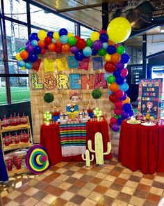 a table with balloons and decorations on it