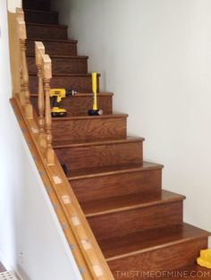 the stairs are made of wood and have yellow tape on them