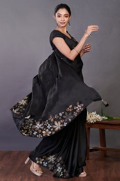 Beautiful black Swarovski floral motifs satin saree. It comes with a matching saree blouse. Shop designer saris online in USA from Pure Elegance. Disclaimer: The actual product may vary slightly from the image. These are custom orders, hence expect slight variation in color, placement of the motif or buta. ESTIMATED DELIVERYBecause this is a custom order, it would take about 4 weeks from the date of purchase. RETURN POLICYThis product is a custom order and cannot be returned or exchanged. Black Silk Saree With Resham Embroidery, Black Silk Pre-draped Saree With Resham Embroidery, Festival Saree With Resham Embroidery In Satin, Designer Black Tussar Silk Saree, Festival Satin Saree With Resham Embroidery, Festive Satin Saree With Resham Embroidery, Diwali Satin Saree With Resham Embroidery, Black Silk Pre-draped Saree For Evening, Fitted Tussar Silk Pre-draped Saree For Party