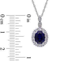 This shimmering fashion pendant is a terrific finish to an already-beautiful anytime look. Crafted in cool 14K white gold, the drop features an 8.0 x 6.0mm oval-shaped lab-created bright blue sapphire lined in sparkling white topaz. Duos of petite diamond accents in tiny marquise-shaped frames adorn the layered bail. Buffed to a brilliant luster, this elegant pendant suspends along a 17.0-inch Singapore chain that secures with a spring-ring clasp. Elegant Sapphire Necklace For Anniversary, Elegant Sapphire Necklace With Brilliant Cut, Elegant Sapphire Necklace With Prong Setting, Elegant Sapphire Drop Necklaces, Elegant Jewelry With Halo Setting In Drop Shape, Elegant Drop Jewelry With Halo Setting, Elegant Sapphire Necklace With Diamond Cut, Elegant Sapphire Necklace With Polished Finish, Elegant Sapphire Gemstone Necklace