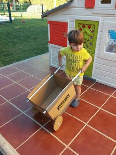 a little boy playing with a toy wagon