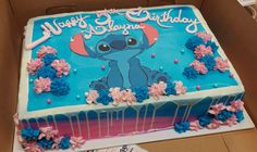 the birthday cake is decorated with blue and pink frosting