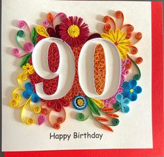 a 90th birthday card with paper flowers and the number 90 on it's front