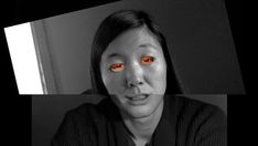 a woman with red eyes looking at the camera