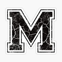 the letter m is made up of cracked black and white paint sticker on a white background