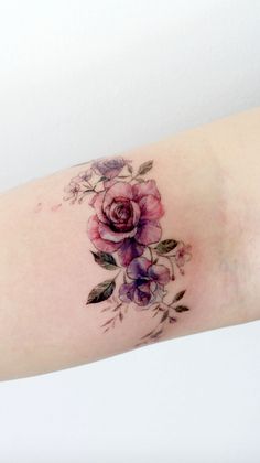 a close up of a person's arm with flowers on it