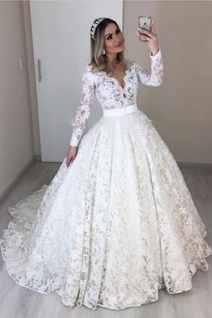 a woman taking a selfie in her wedding dress