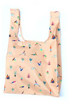 an orange shopping bag with colorful birds and cactuses on it's front, against a white background