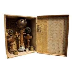 an open wooden box filled with lots of different items