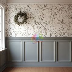 an empty room with a wreath on the wall and wood flooring in front of it