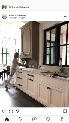 a woman is standing in the kitchen with her feet on the counter and looking out the window