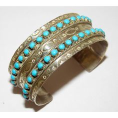 For your consideration is this fabulous Zuni sterling silver and legendary Sleeping Beauty Mine turquoise cuff bracelet in wonderful condition. The bracelet features a classic hand etched tribal design in sterling silver accented with a 2 rows of stunning turquoise "snake eye" design cabochons. The cuff measures about 6 1/4" inside circumference including gap. The gap is about 1" wide and can be carefully adjusted. Marked "sterling" and stamped with the artist's hallmark. Wonderful addition to any jewelry collection! Traditional Turquoise Sterling Silver Cuff Bracelet, Traditional Engraved Turquoise Bracelets, Traditional Turquoise Engraved Bracelet, Traditional Stamped Turquoise Jewelry, Antique Stamped Turquoise Jewelry, Vintage Native American Jewelry, Native American Necklace, Native American Rings, Turquoise Bracelet Cuff