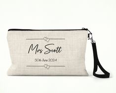 This Personalised Wedding Cosmetic Bag is a great gift idea for a bride to be. The make up bag is designed for a variety of purposes from storing pens and pencils, make up or essentials for a night out. The cosmetic bag is personalised with a name and date. The Personalised Wedding Cosmetic Bag is made from a thick polyester that is cream coloured, with a look and feel of linen canvas with removable black strap  The overall measurements are:  Width 24cm, Height 15cm. Wedding Pouch Bag With Zipper, Wedding Zippered Pouch Bag, Rectangular Wedding Gift Pouch, Rectangular Zipper Pouch Bag For Bridesmaid Gift, Elegant Rectangular Bag For Wedding Gift, Rectangular Bridesmaid Gift Bag With Zipper Pouch, Elegant Personalized Wedding Bags, Rectangular Removable Pouch For Wedding, Bride Gift Bags