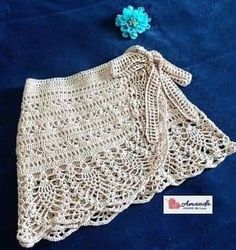 a crocheted shawl with a flower on it