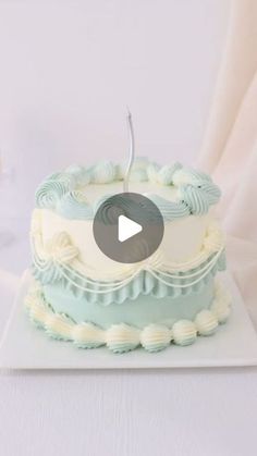 a blue and white cake sitting on top of a table