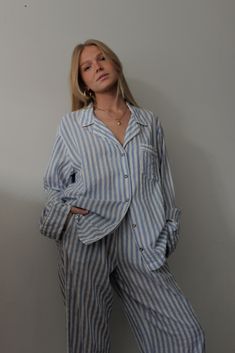 The Tilly Top is a beautiful, vintage-inspired button-up top perfect for styling with trousers or even paired with a swim look. Our Tilly blouse features a nod to classic vintage pajamas and modern edits for a look beyond sleep apparel. The soft gauzy striped fabric is essential for warm weather but can be worn year-round. We love pairing our Tilly Top with our best-selling Townes Trousers in Cotton Twill and with a modern go-to leather slide. 70% Cotton / 30% Rayon Made in the USA Relaxed sligh Sleep Lounge Wear, Summer Blouse For Pajama Party, Relaxed Spring Blouse For Loungewear, Relaxed Blouse For Spring Loungewear, Spring Pajama Party Blouse, Oversized Pyjamas, Classic Sleepwear For Pajama Party In Spring, Striped Summer Blouse With Button Cuffs, Classic Summer Sleepwear For Loungewear