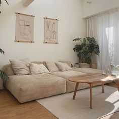 a living room filled with furniture and plants