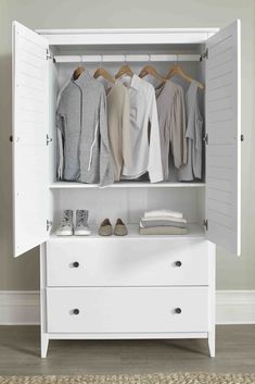 an open closet with clothes and shoes on it