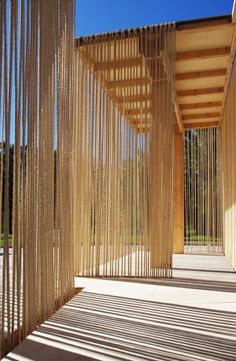 an open room with wooden slats on the wall and flooring in front of it