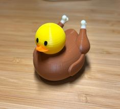 a rubber ducky toy sitting on top of a wooden table