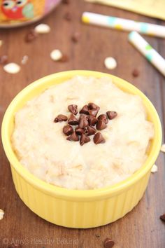 a yellow bowl filled with oatmeal sitting on top of a wooden table