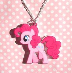 a pink pony with big eyes is shown on a necklace that has a chain attached to it