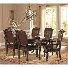 a dining room table with chairs and a chandelier