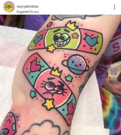 a person with a tattoo on their arm that has an image of cartoon characters on it