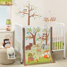 a baby crib bedding set with woodland animals and trees on it, including an owl