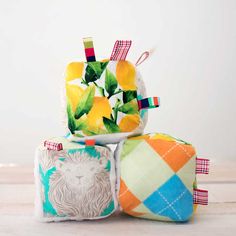 three colorfully decorated items sitting on top of each other in front of a white wall