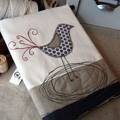 a pair of scissors sitting on top of a table next to some knitting needles and yarn