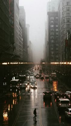 a city street filled with lots of traffic on a rainy day