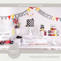 a table topped with cakes and desserts on top of a white table covered in bunting