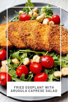 fried eggplant with arugula caprese salad on a black plate