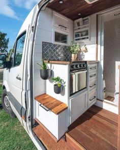 the interior of a tiny home with wood flooring and white walls, including an oven