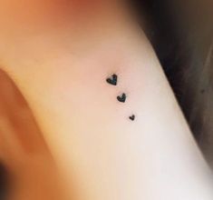 small black hearts tattoo on the wrist