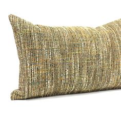 a pillow that is sitting on top of a white surface with a brown and green pattern