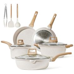 an assortment of white pots and pans with wooden handles, spatulas and utensils