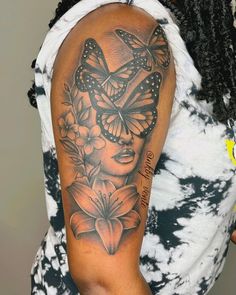 a woman with a butterfly tattoo on her arm