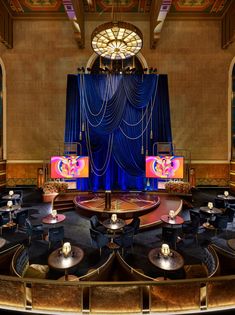 the stage is set up for a show with blue curtains and chandeliers on it