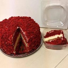 a red velvet cake with one slice cut out and the rest in plastic container next to it